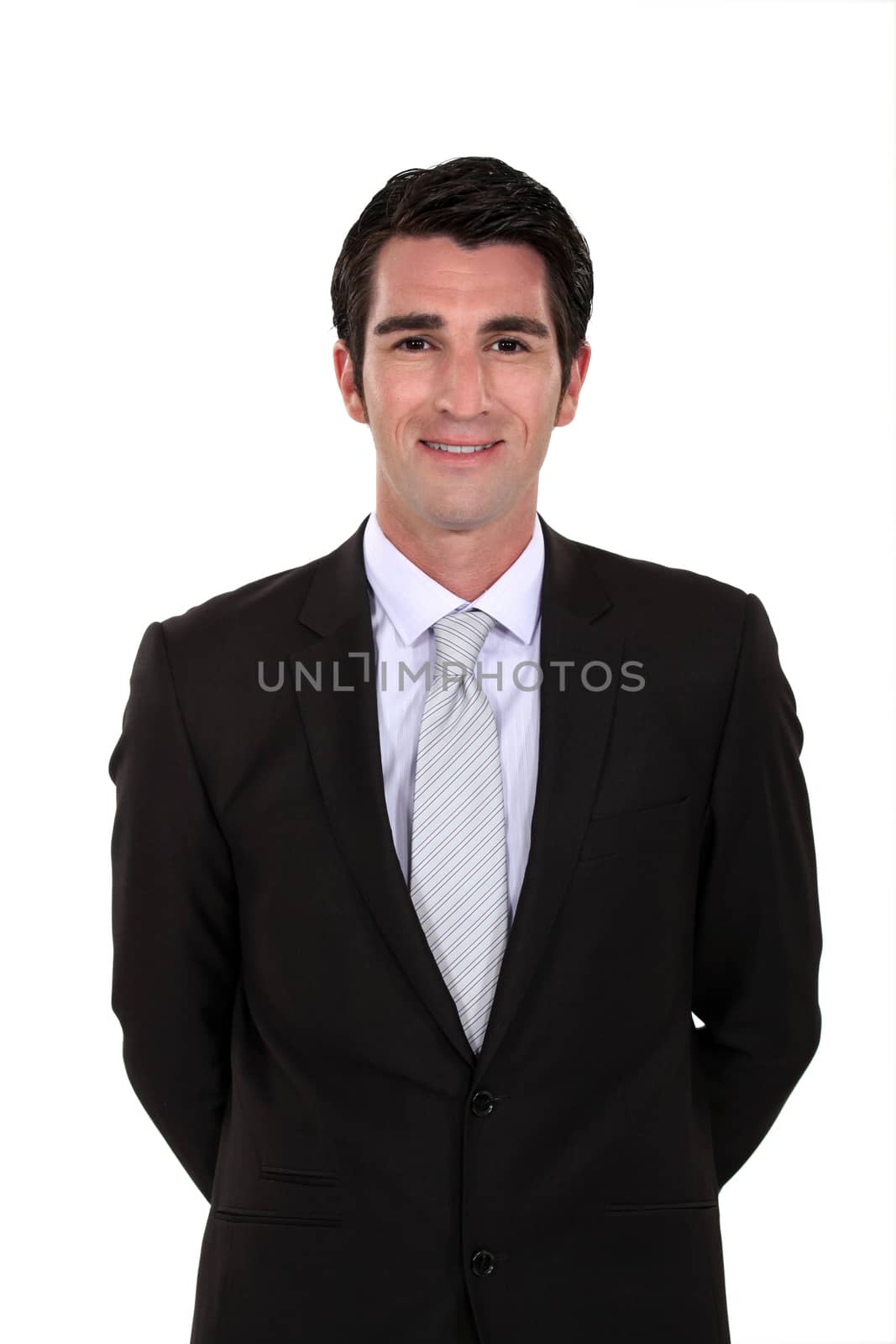 handsome businessman posing by phovoir