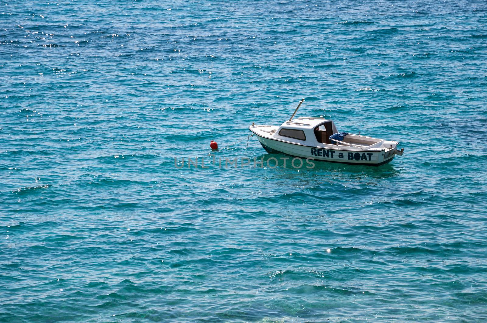 Boat for rent on a turquoise sea.