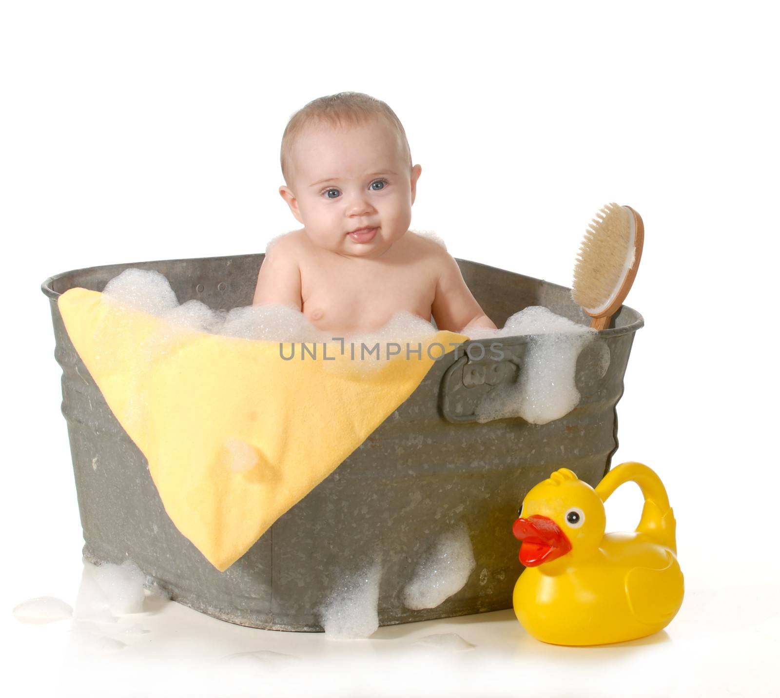 cute baby in a basin with soap suds 