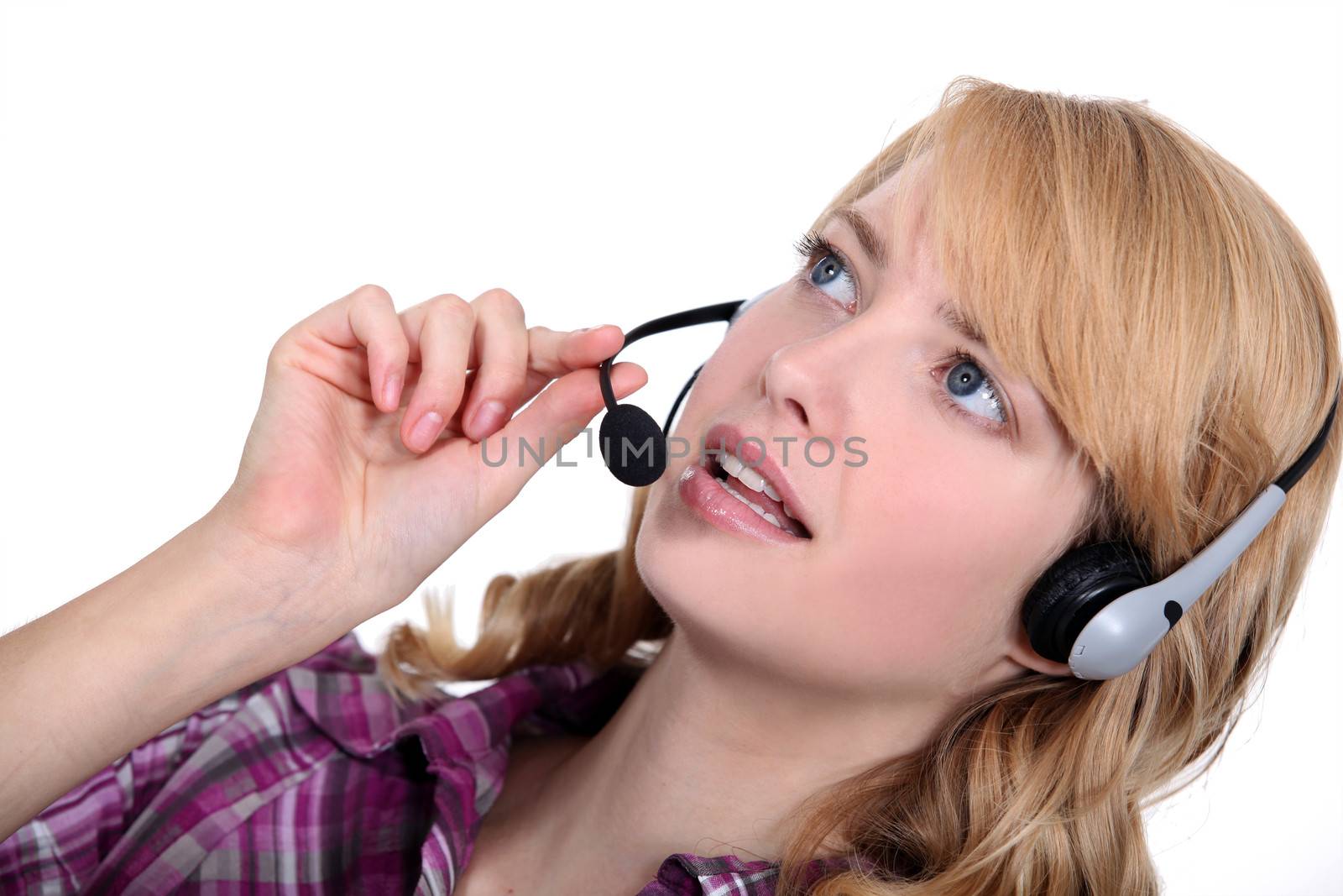 Woman with a telephone headset by phovoir
