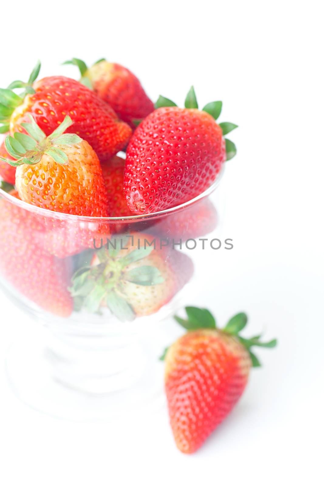 big red strawberries in a glass bowl by jannyjus