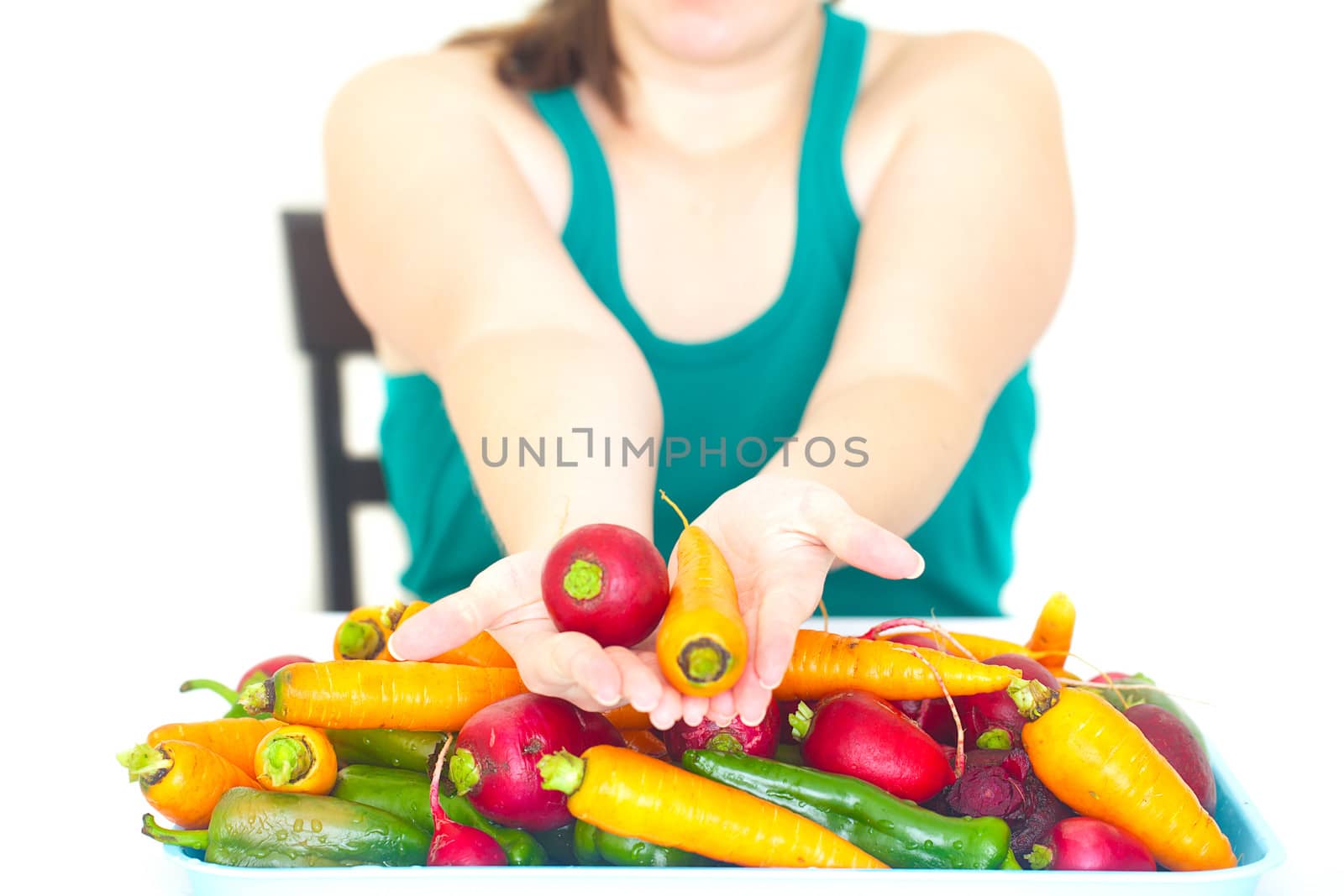 young woman holding in the hand radish and the heap of vegetable by jannyjus