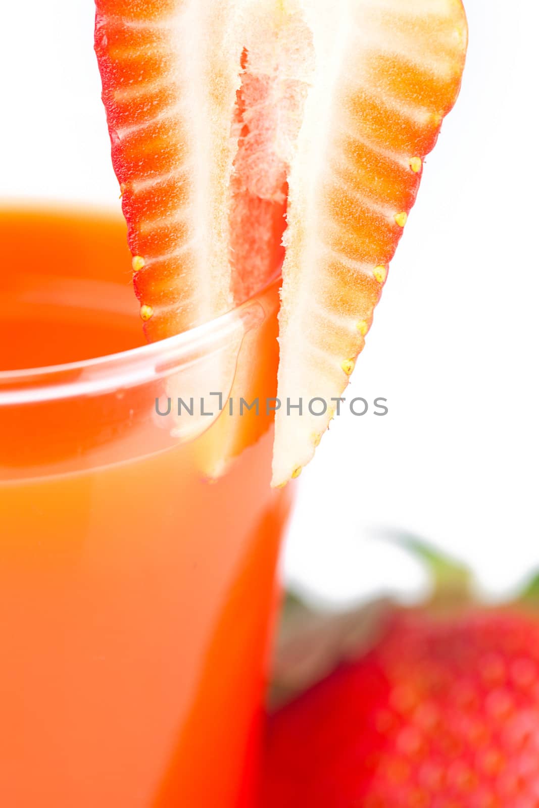 strawberry and a glass of strawberry juice isolated on white by jannyjus
