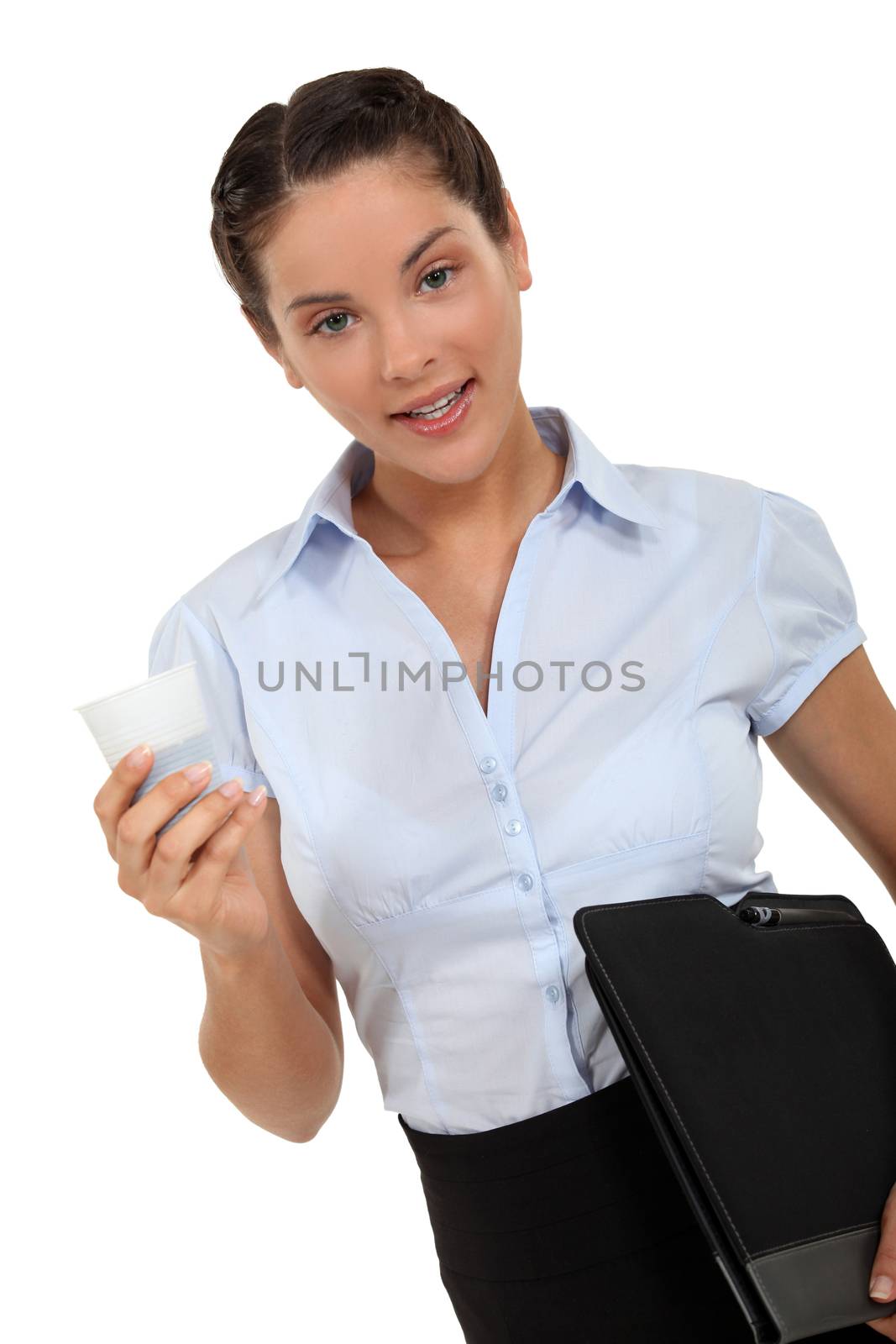 Woman carrying a laptop and cup of coffee by phovoir