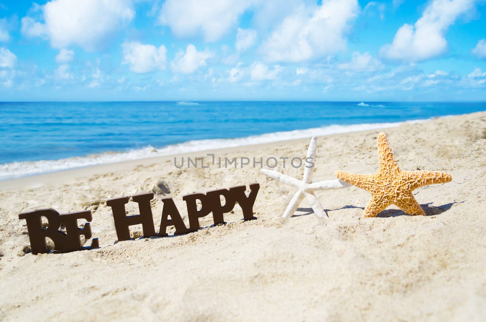 Sign "Be Happy" and two starfishes on the sandy beach by EllenSmile
