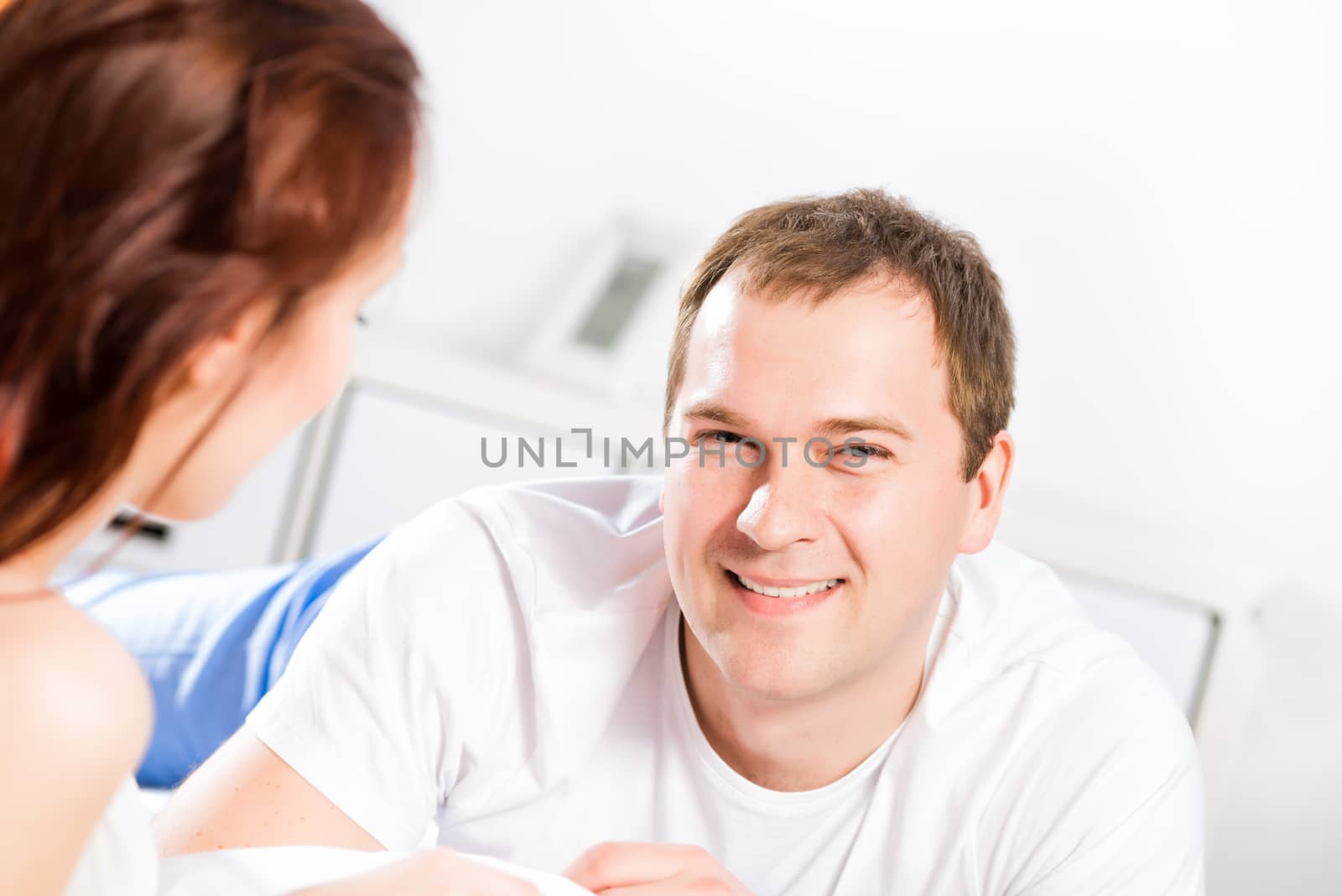 young man lying in bed with his girlfriend, spend time together at home