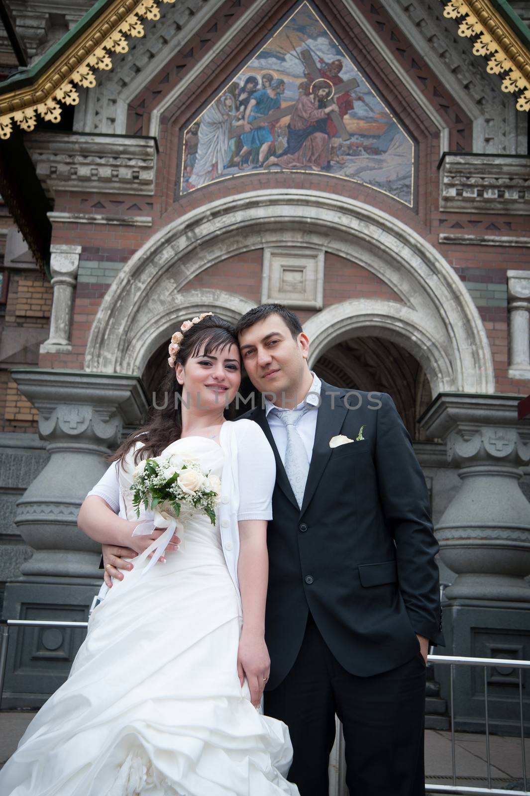 bride and groom near the temple