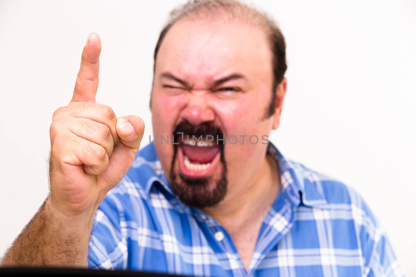 Horizontal portrait of an angry middle-aged Caucasian man screaming and threatening, isolated on white background