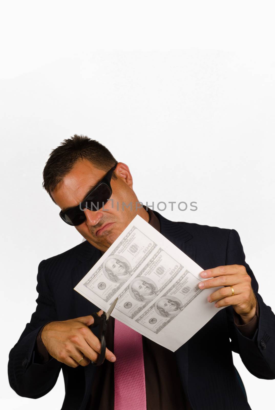 Guy  cutting out fake dollar bills, a concept