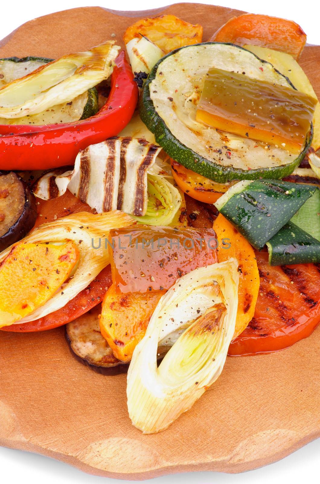 Various Grilled Vegetables with Spices closeup on Wooden plate