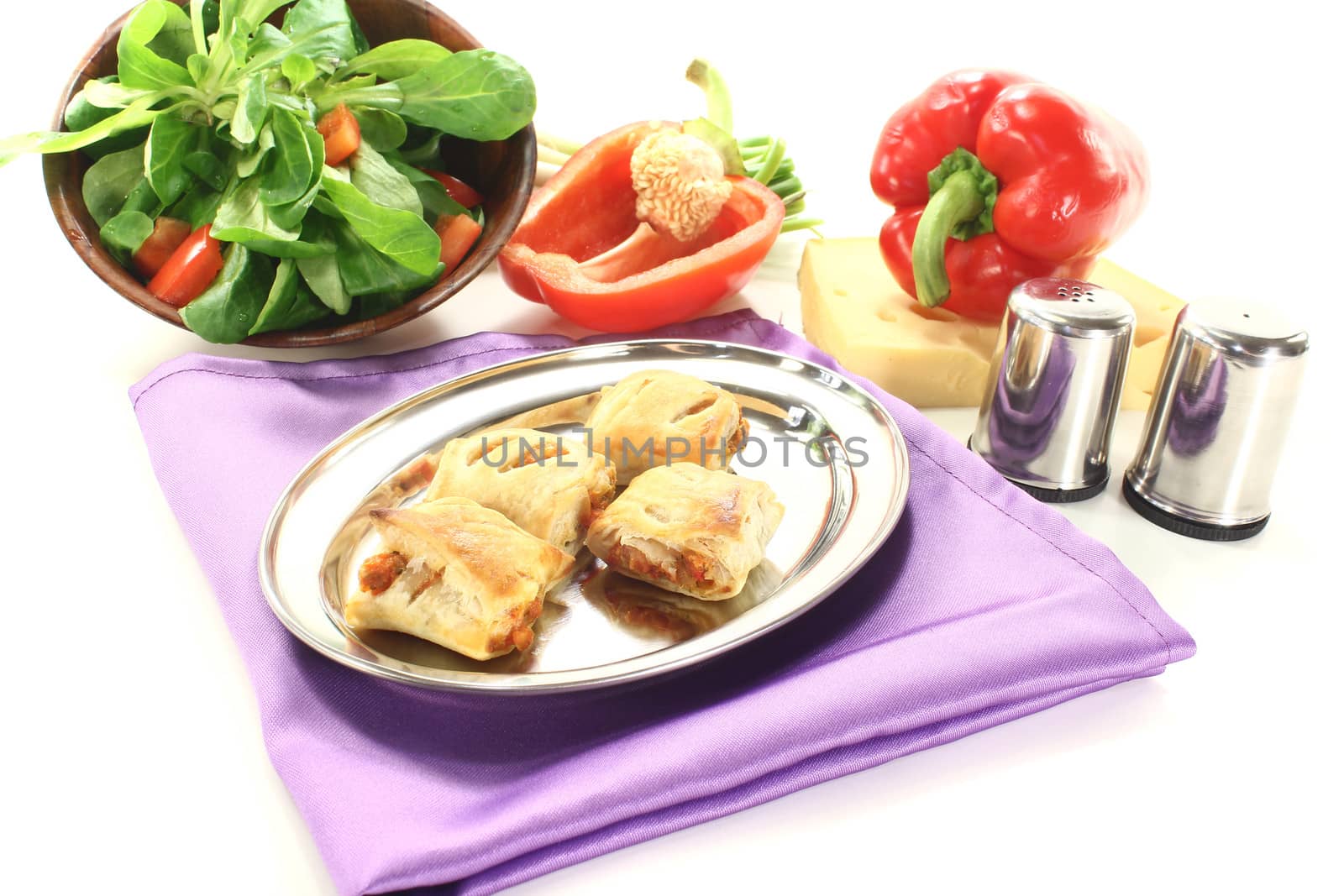 Puff pastry with bell peppers and cheese filling on a light background