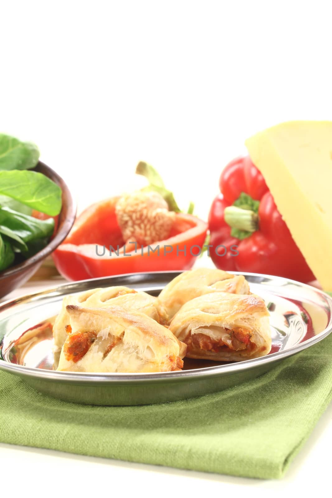 baked Puff pastry with bell peppers and cheese filling on a light background
