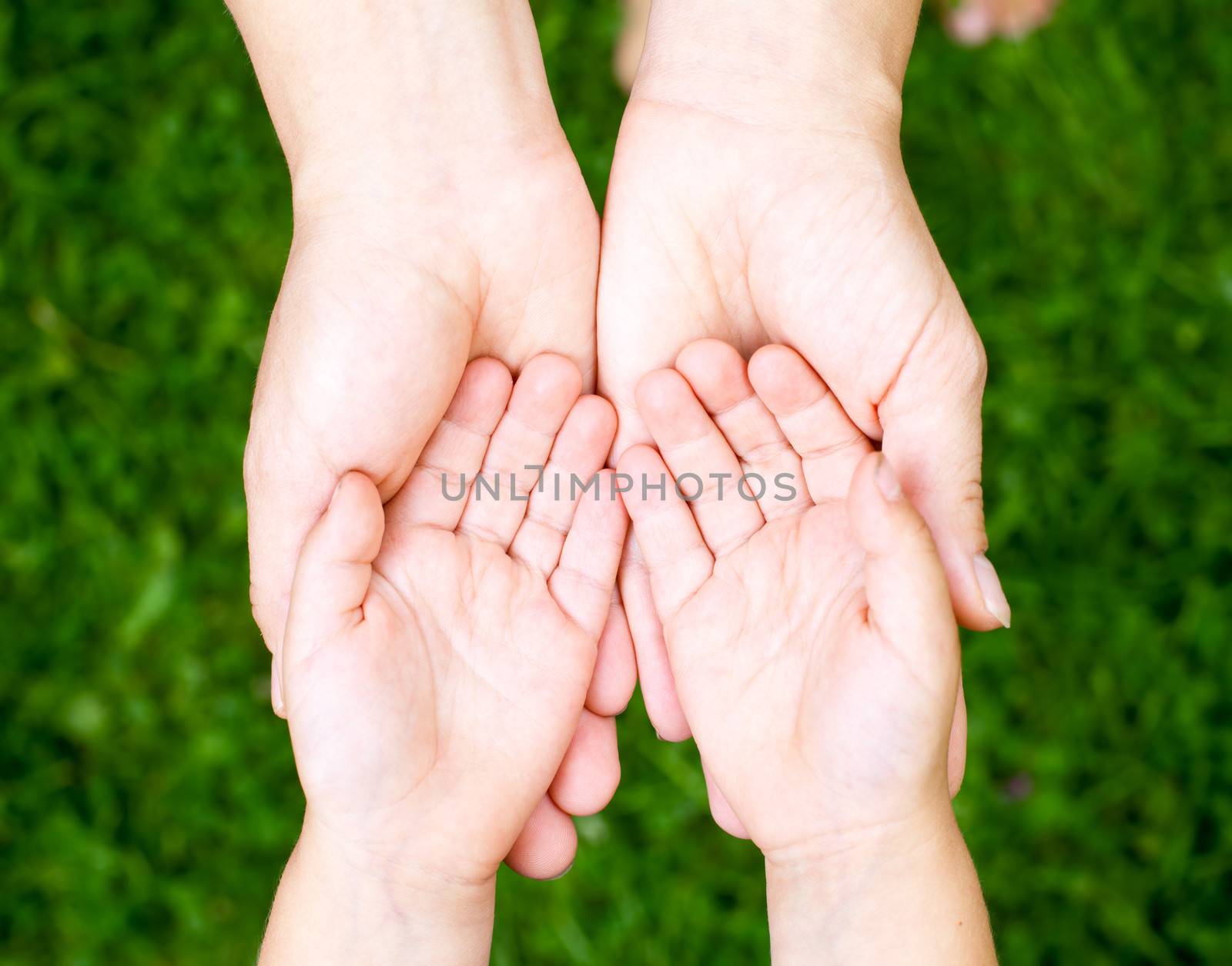 Little girl showing her hands to mother outdoors