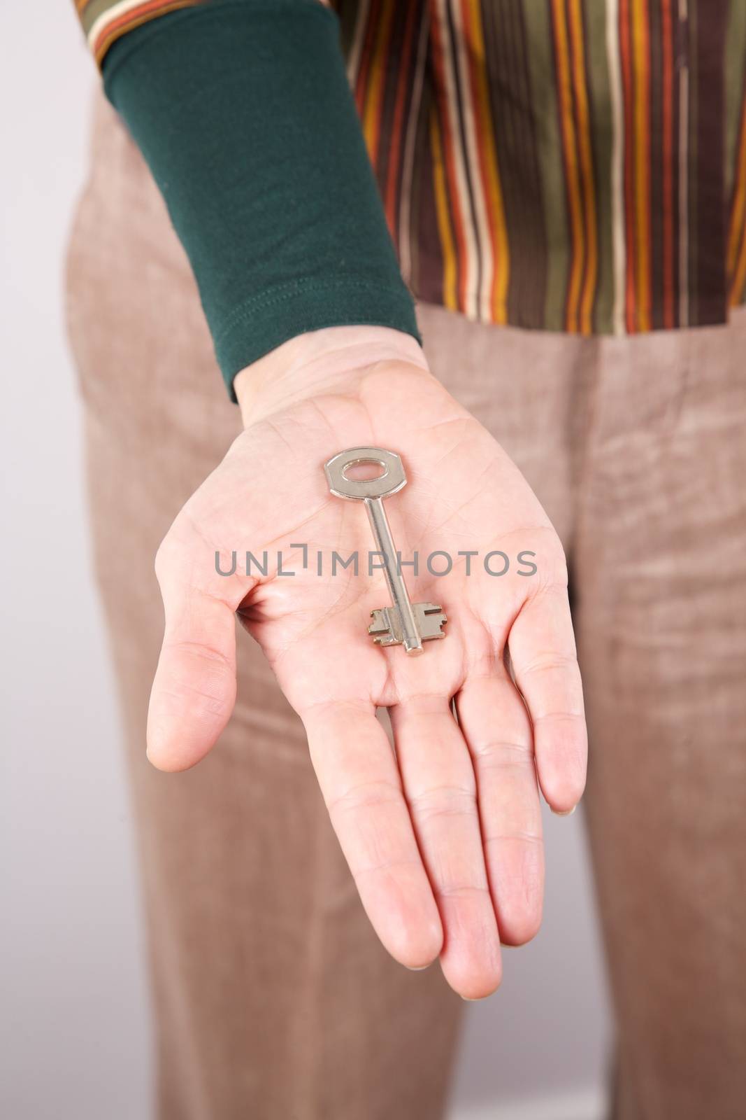 woman detail holding a key in her hand