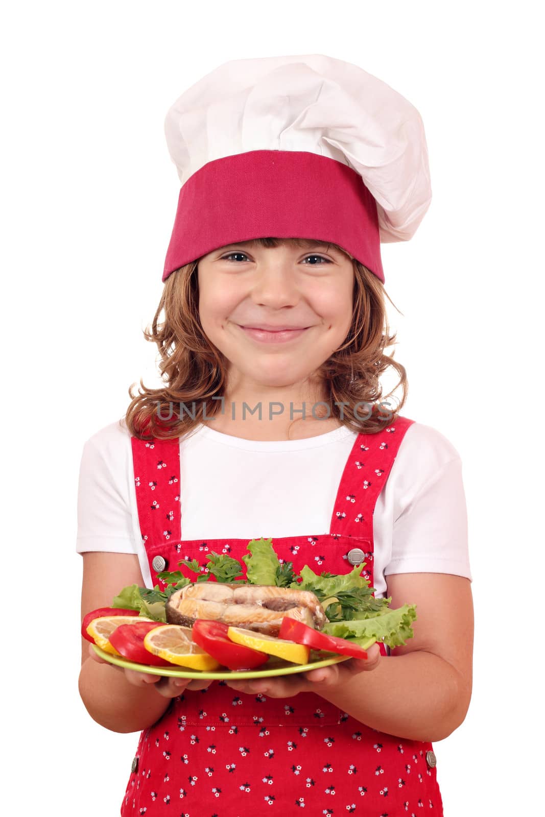 happy little girl cook holding dish with salmon seafood by goce