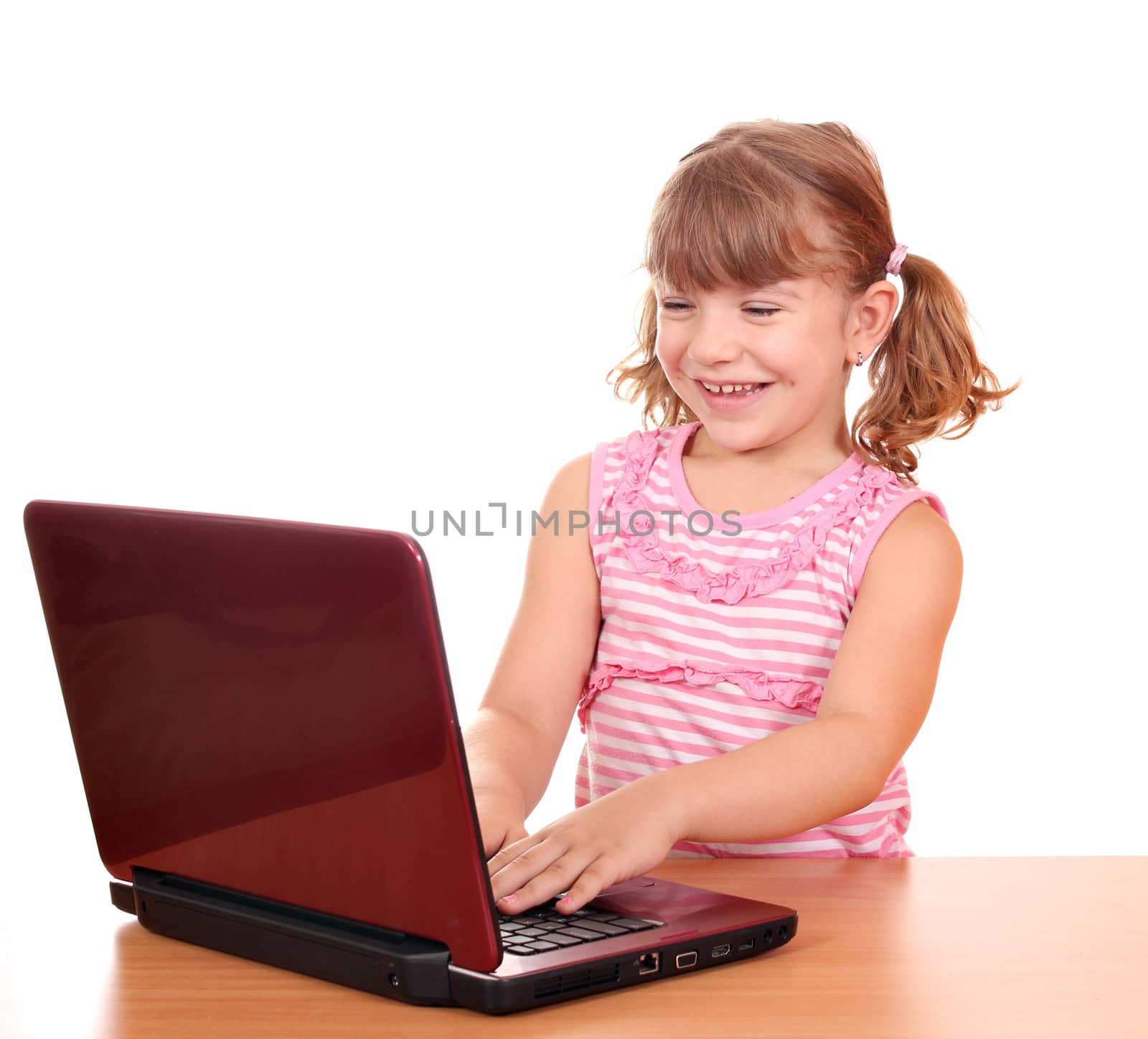 happy little girl play with laptop