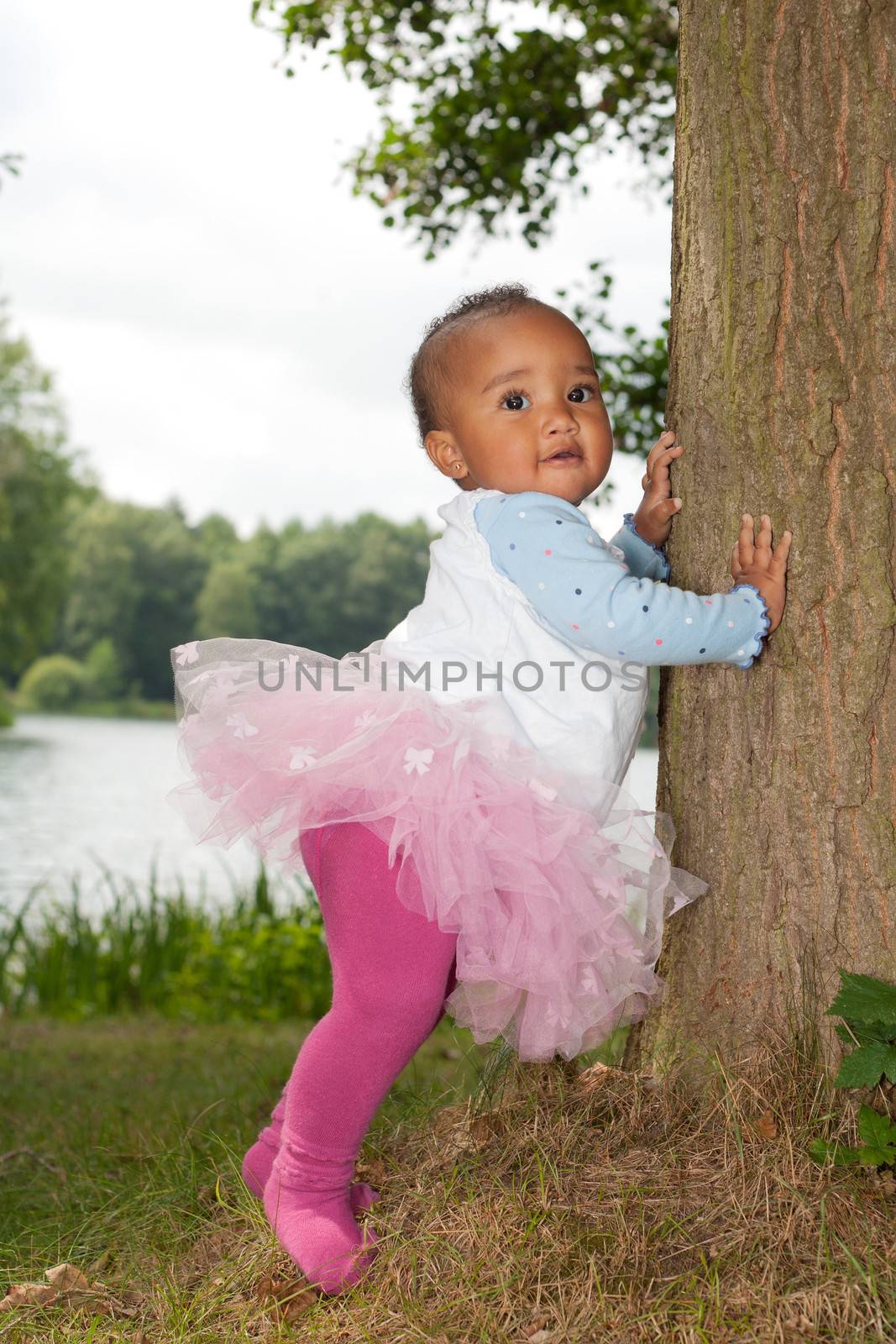African little girl is holding the tree by DNFStyle