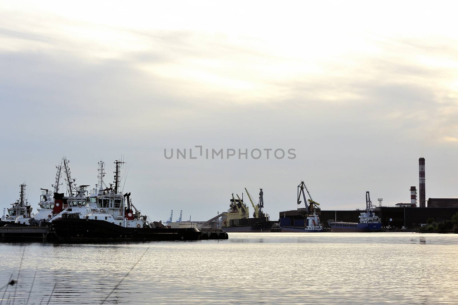 Tug boats with quay for the evening in a creek of Fos on Sea beside Marseille.