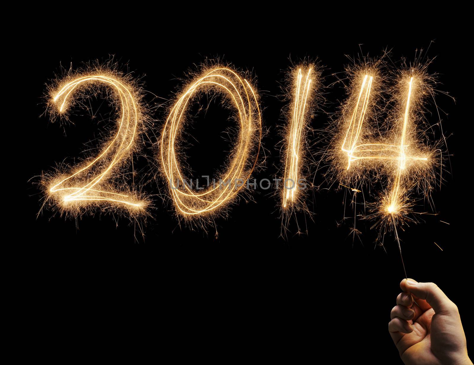 Man writing number 2014 with a sparkler in his hand
