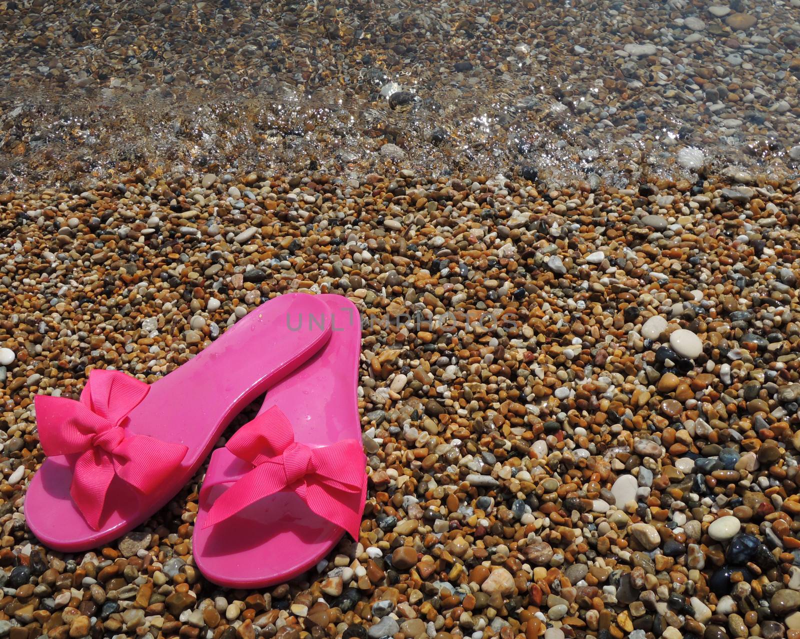 Pink slippers on the beach