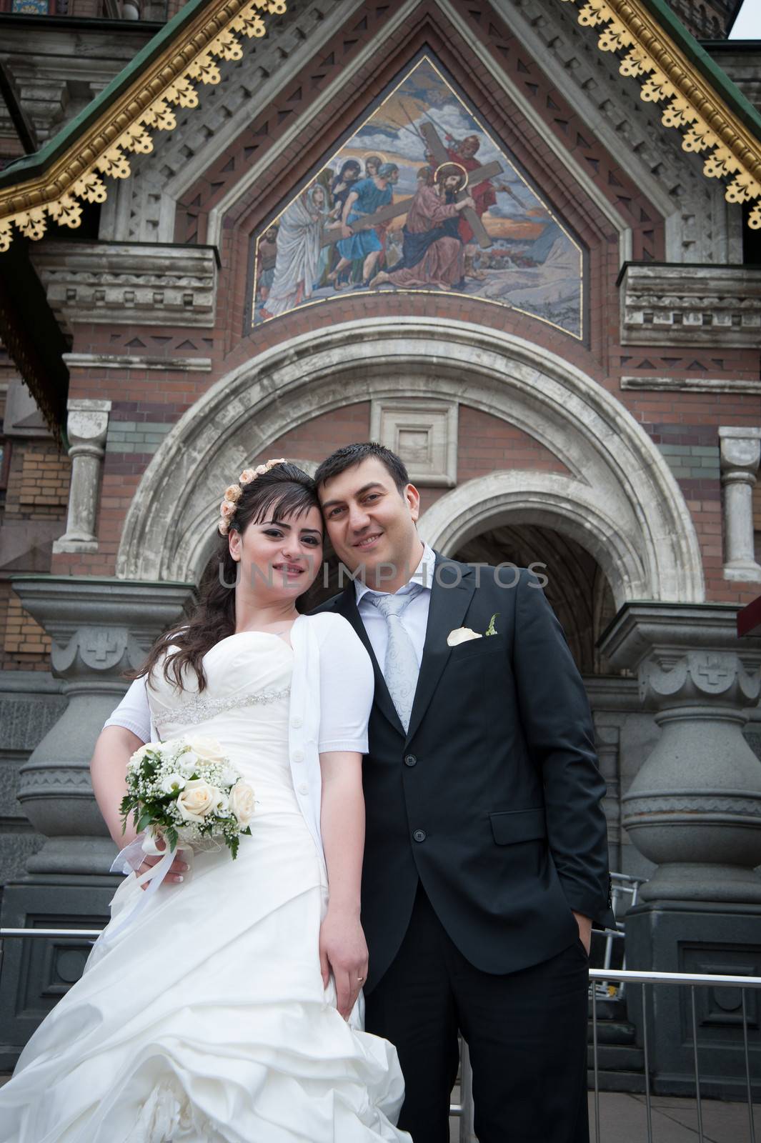 bride and groom near the temple