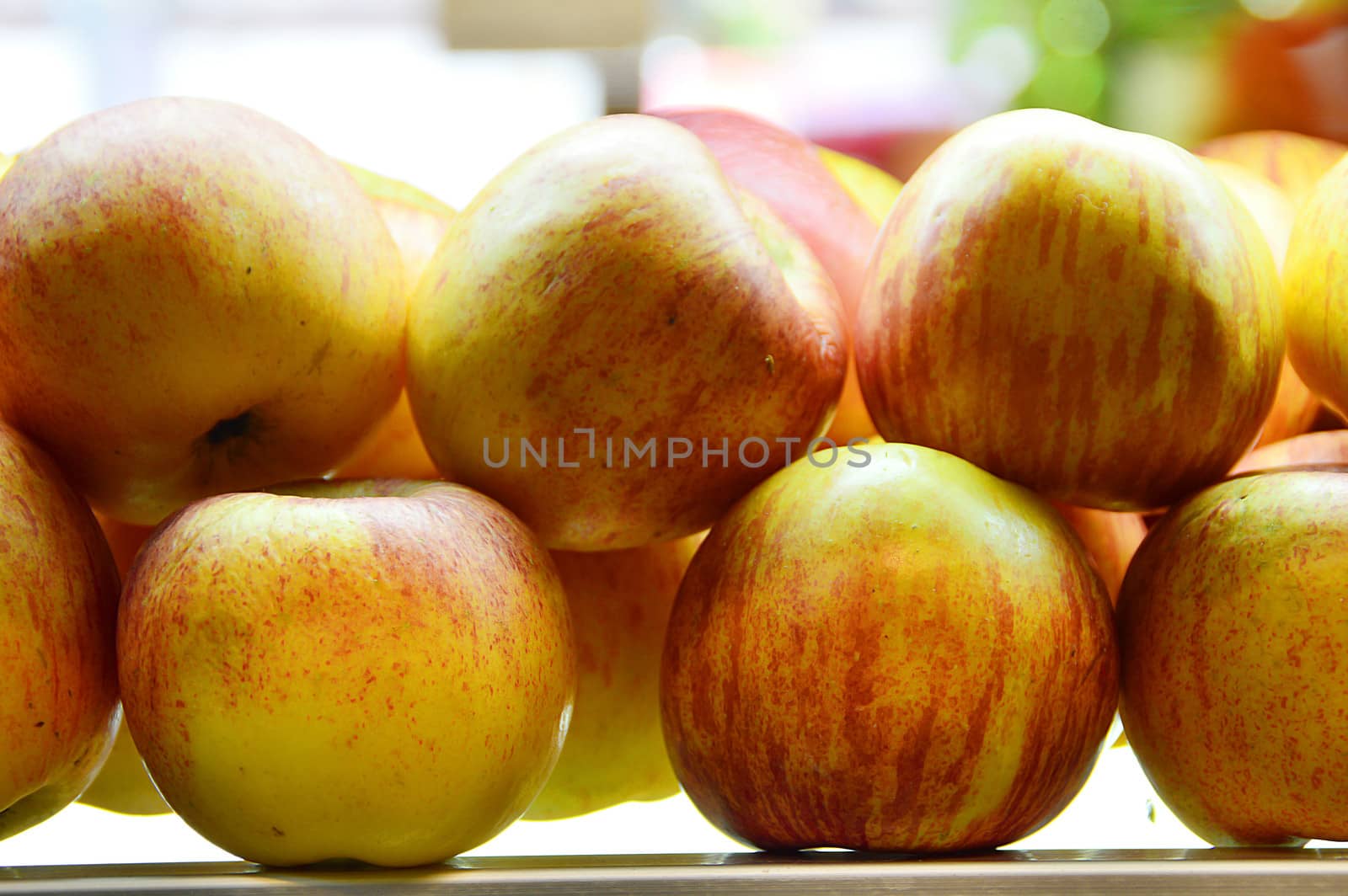 Yummy pile of apples in a market stall by Lekchangply