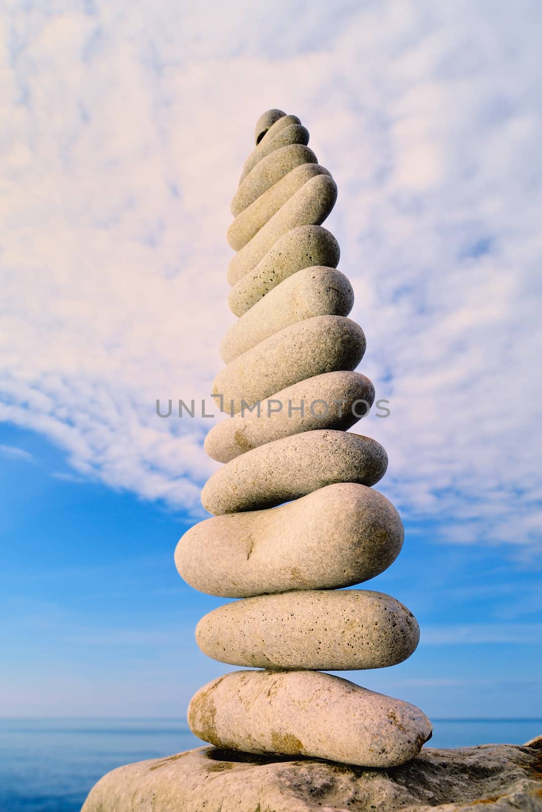 Balancing of white pebbles each other on the seacoast