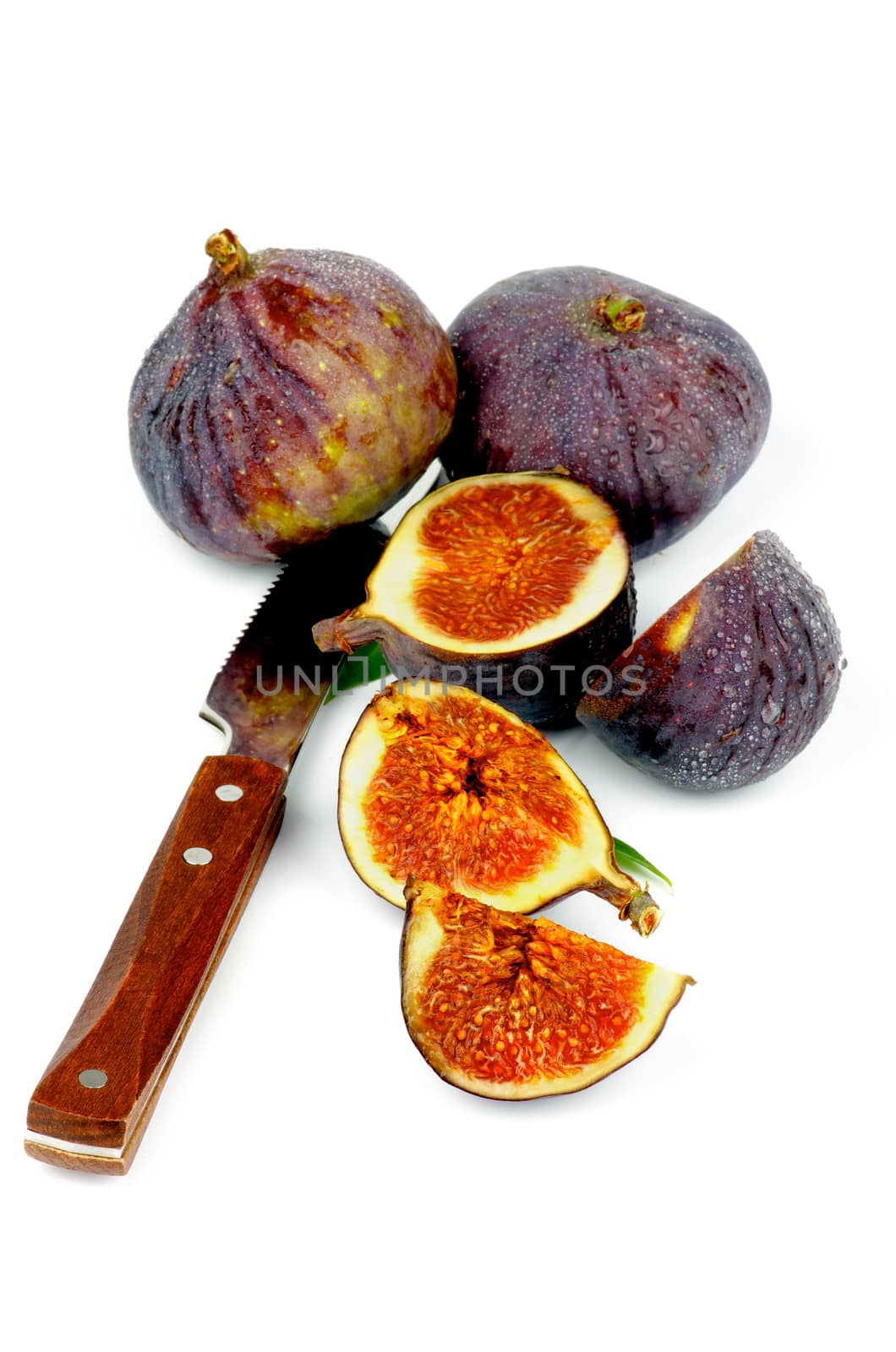 Arrangement of Ripe Figs Full Body and Slices with Table Knife isolated on white background