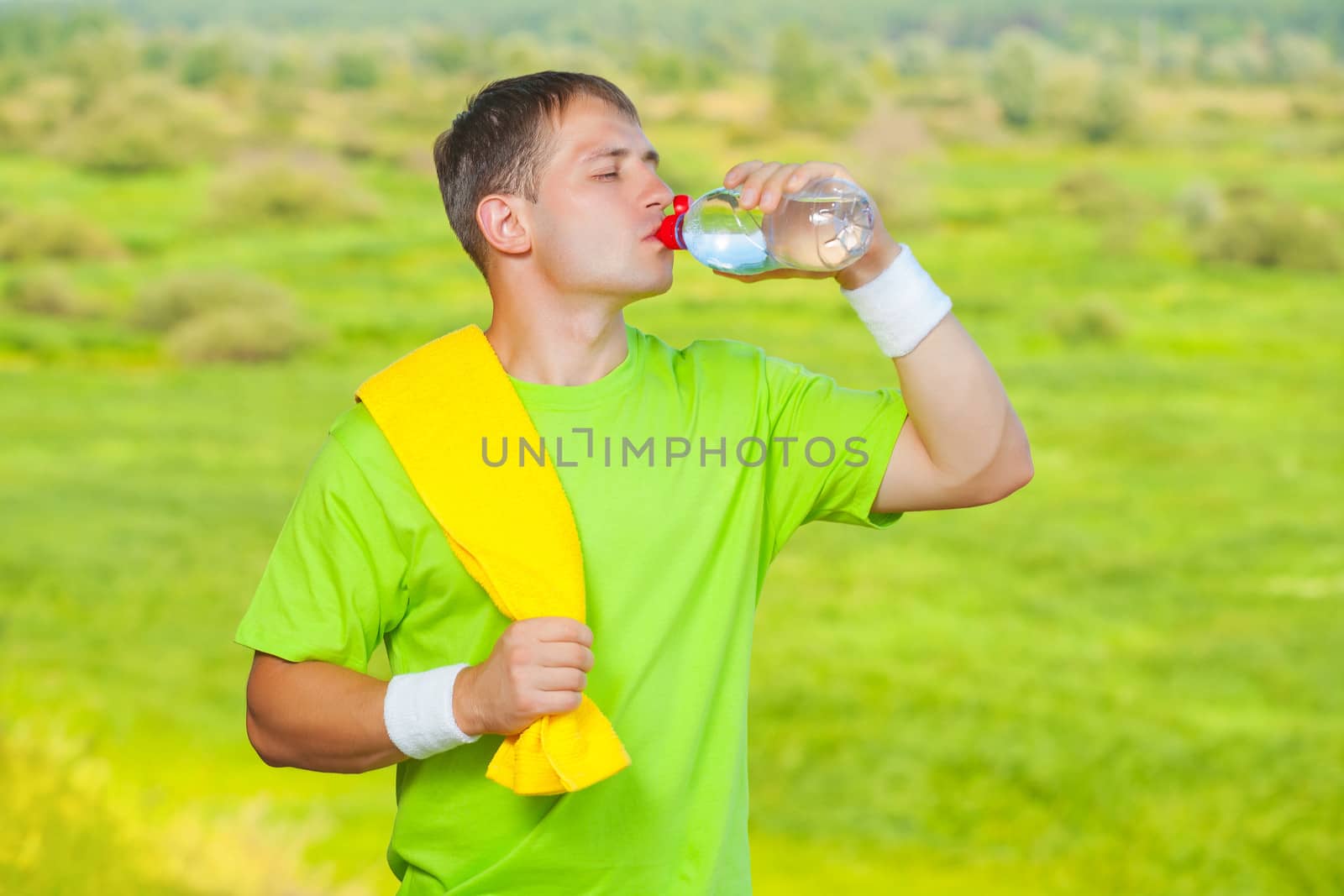 a sportsman drinking water from bottle