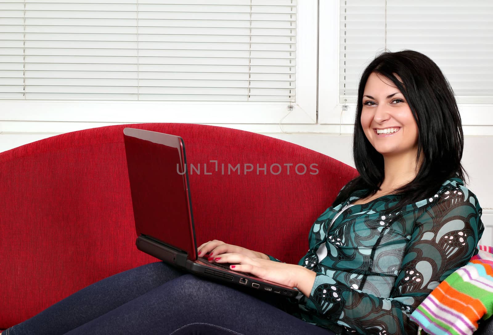 happy beautiful girl with laptop on bed