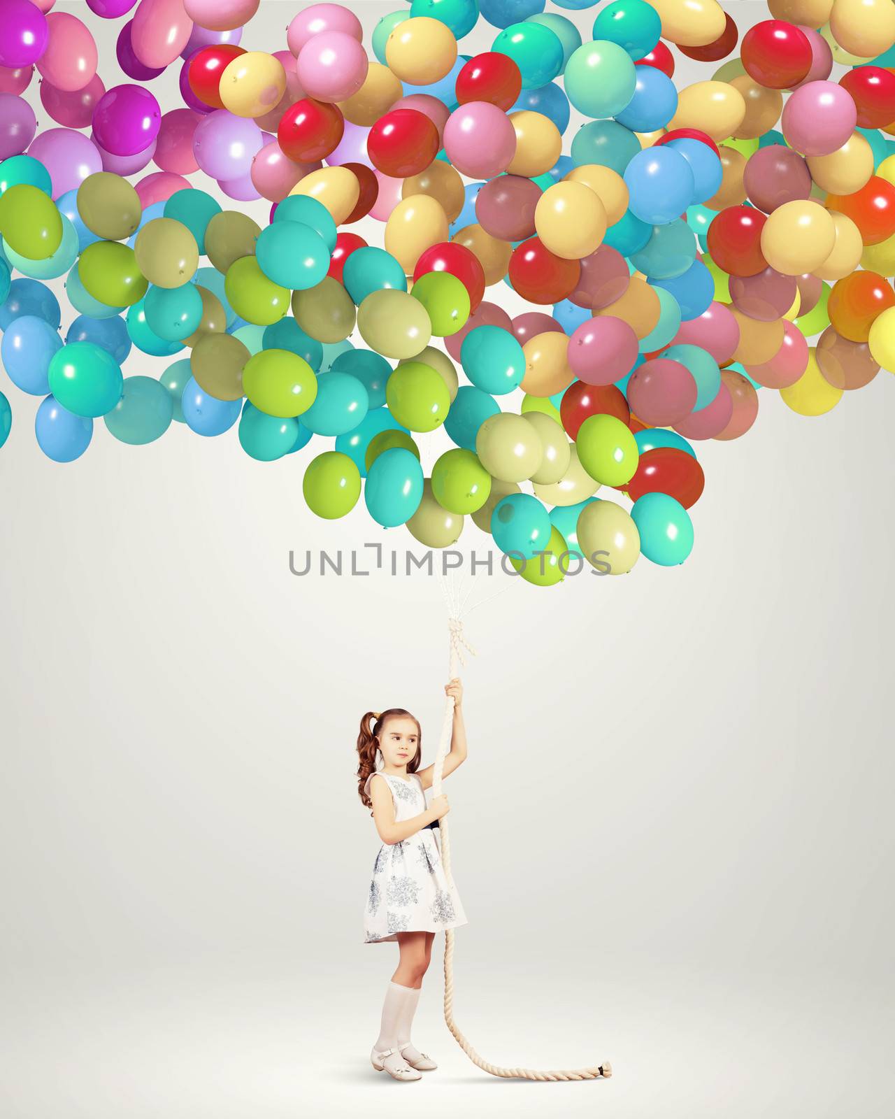 Image of little girl holding bunch of colorful balloons