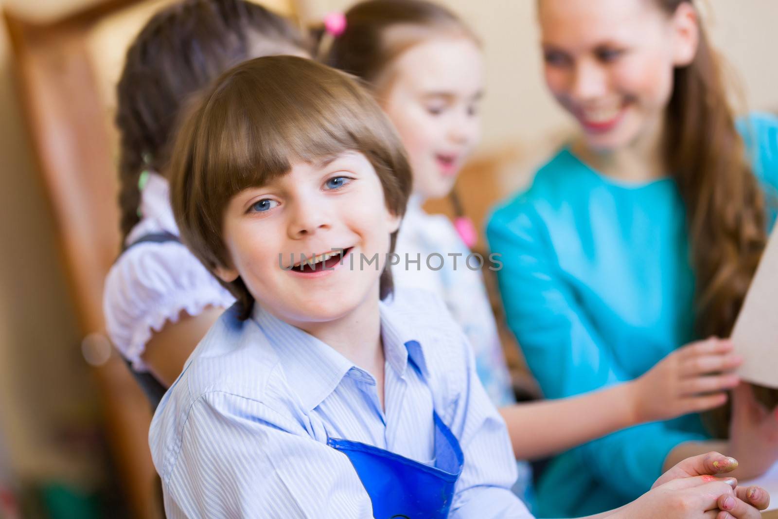 Little children painting and playing at kindergarten