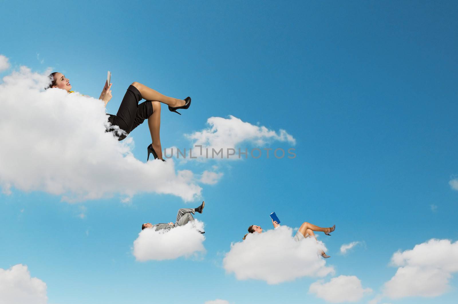 Business people lying on clouds by sergey_nivens