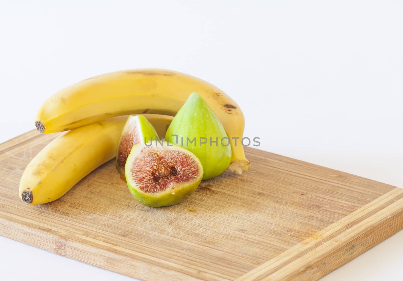 bananas and figs on a kitchen board