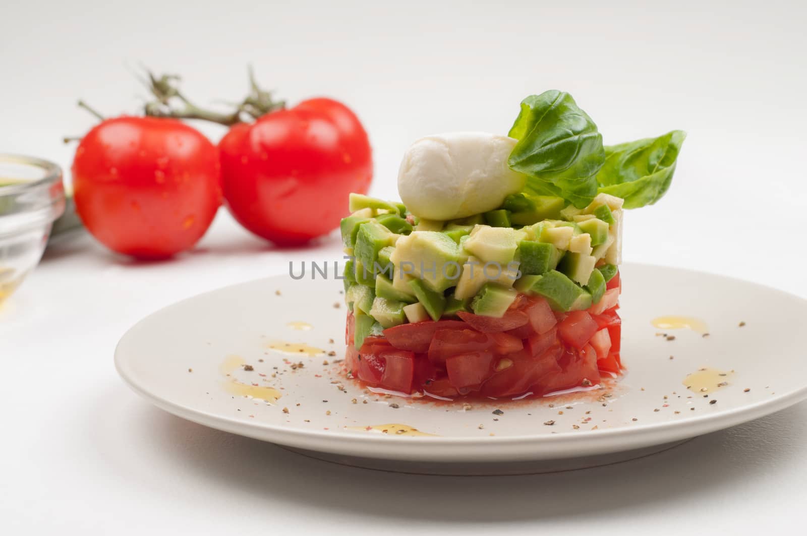 Salad with avocado and tomatoes on the plate