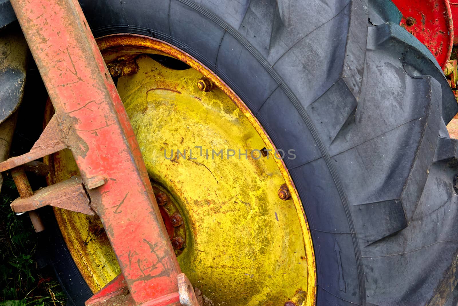 Close details of an old abandoned rusty tractor in a farm