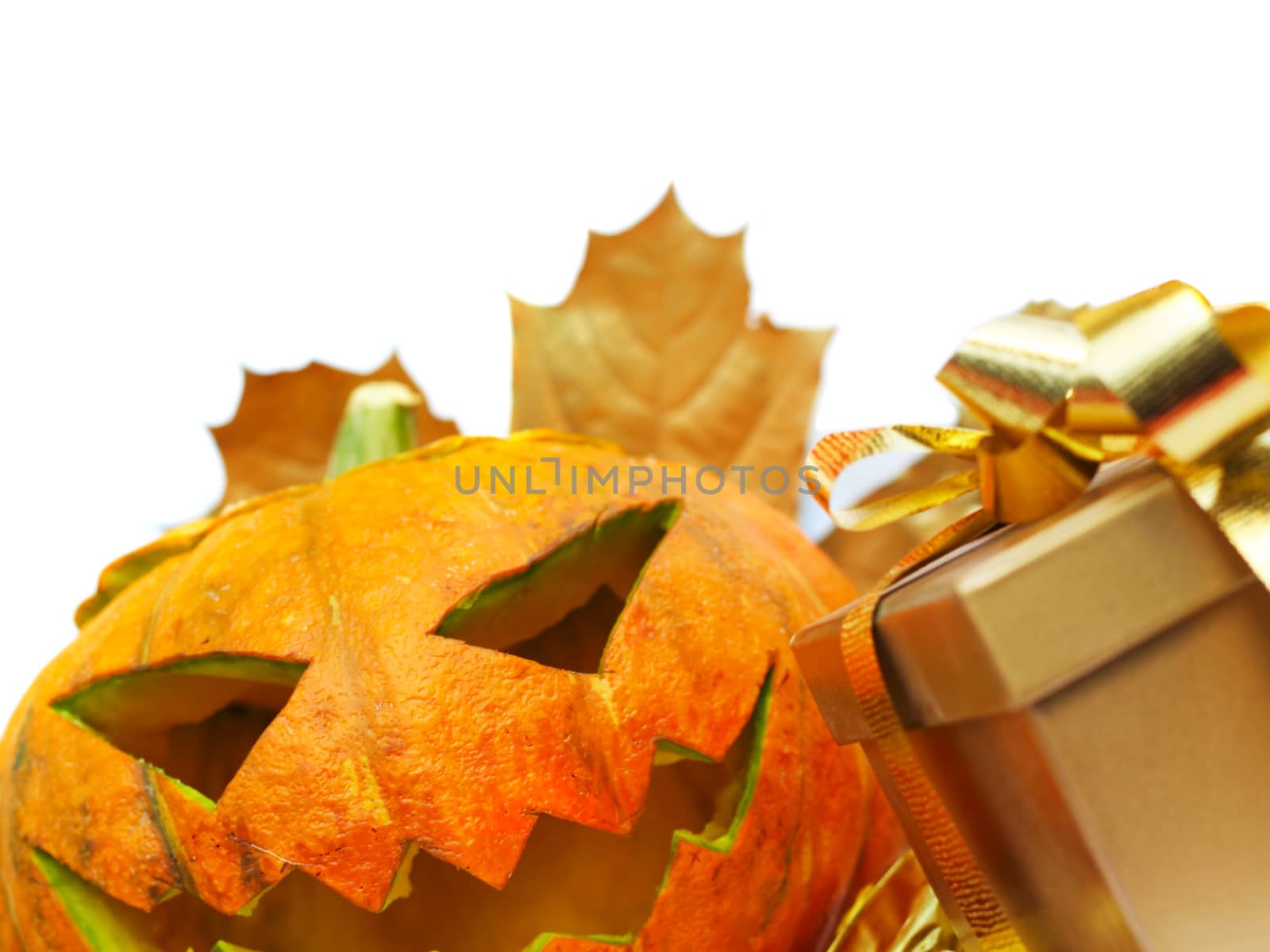 Halloween pumpkin with autumn leafs and gift isolated on white