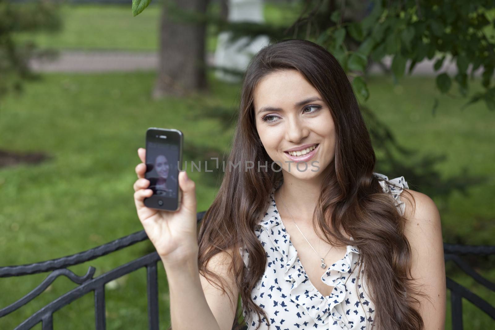 Happy young woman taking pictures on your phone by andersonrise