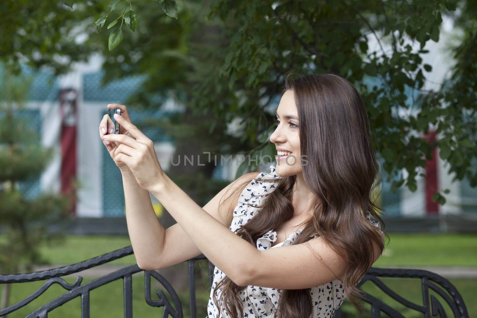 Happy young woman taking pictures on your phone by andersonrise