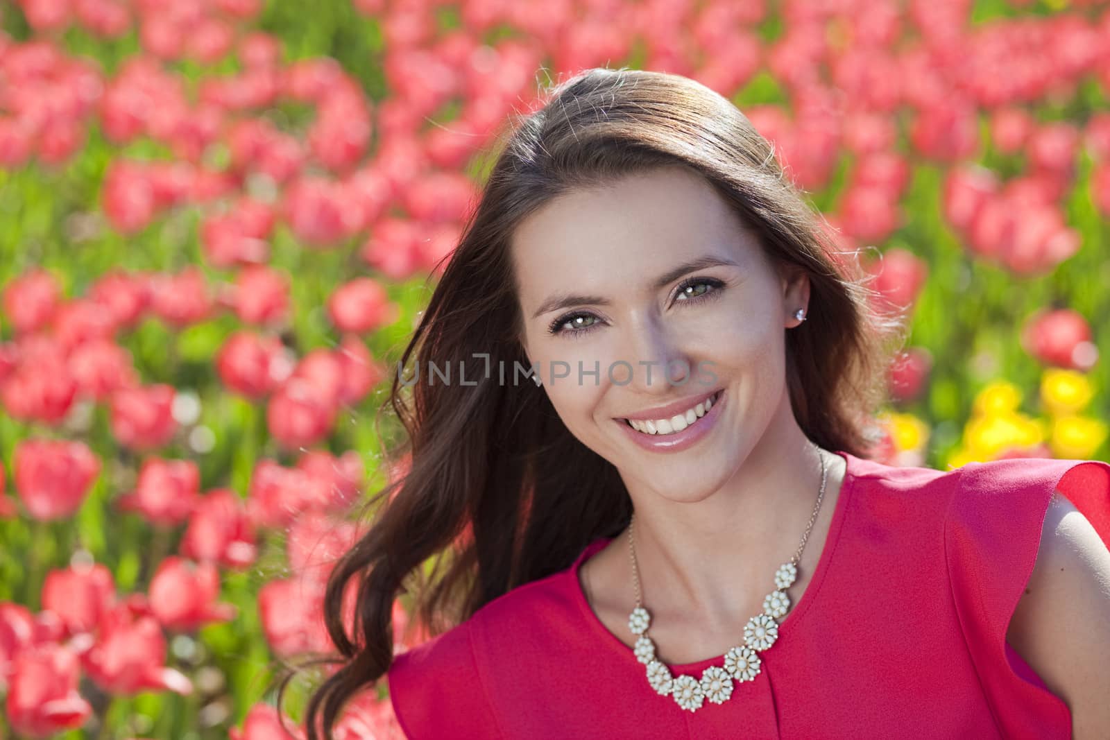 Beautiful young woman with tulips by andersonrise