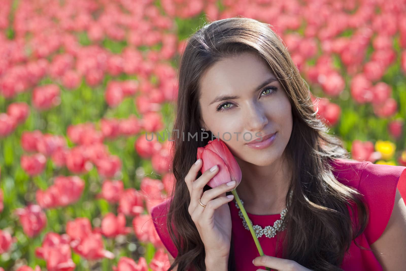 Beautiful young woman with tulips by andersonrise