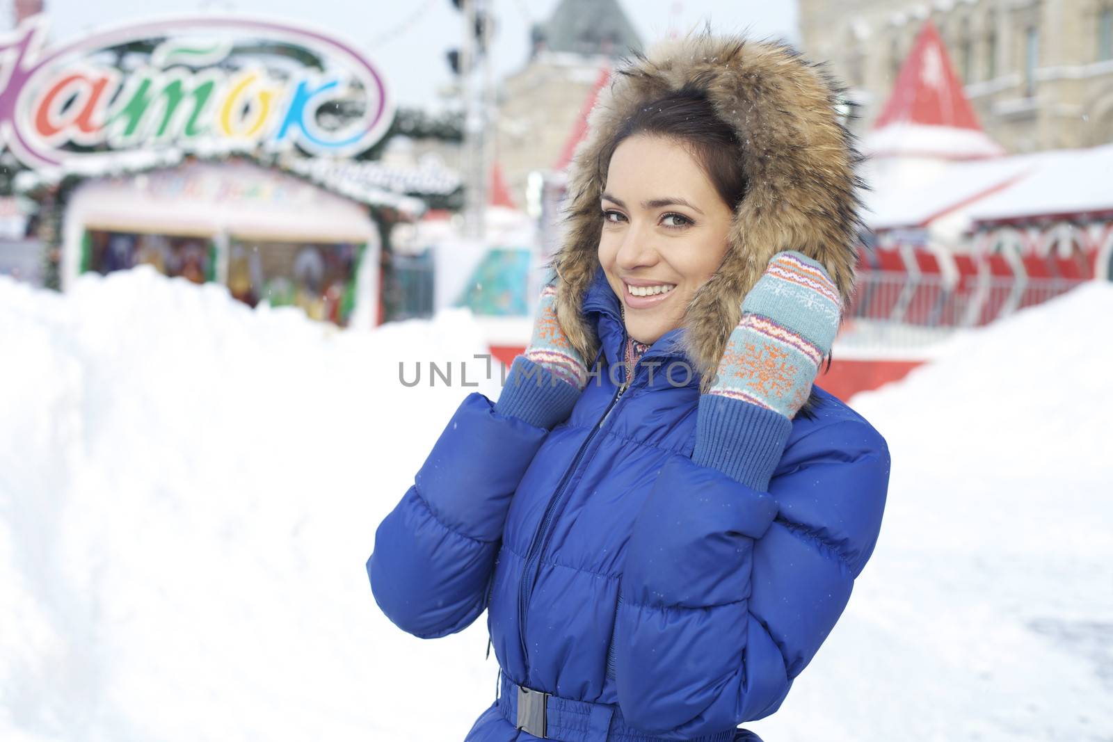 Portrait of a young woman on the background of a winter city by andersonrise