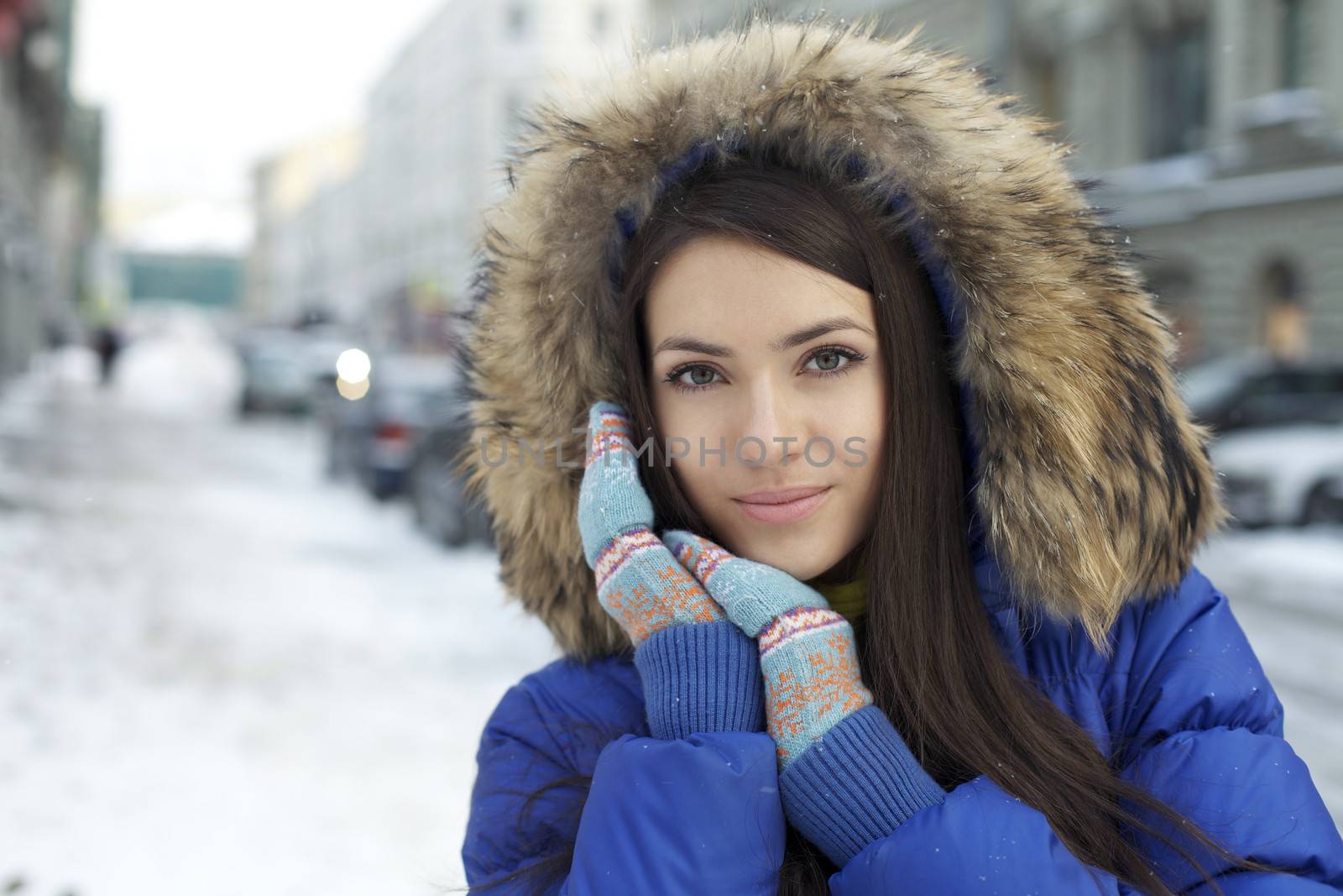 Portrait of a young woman on the background of a winter city