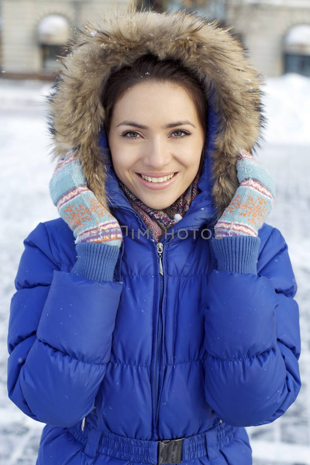 Young woman walking down snow covered street by andersonrise
