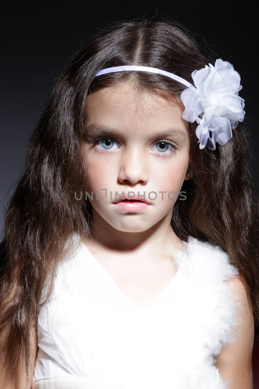 close up portrait of young beautiful little girl with dark hair