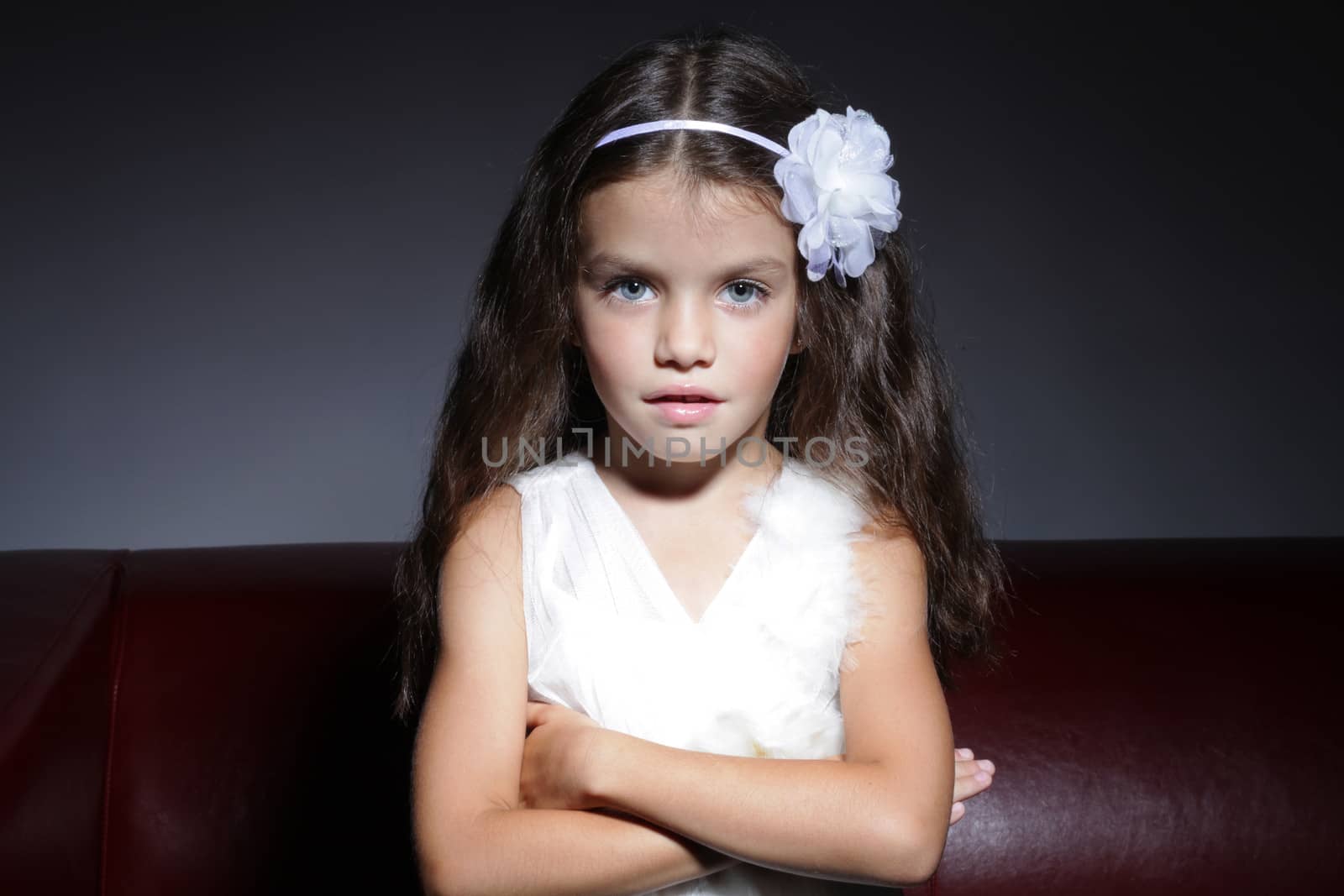 close up portrait of young beautiful little girl with dark hair