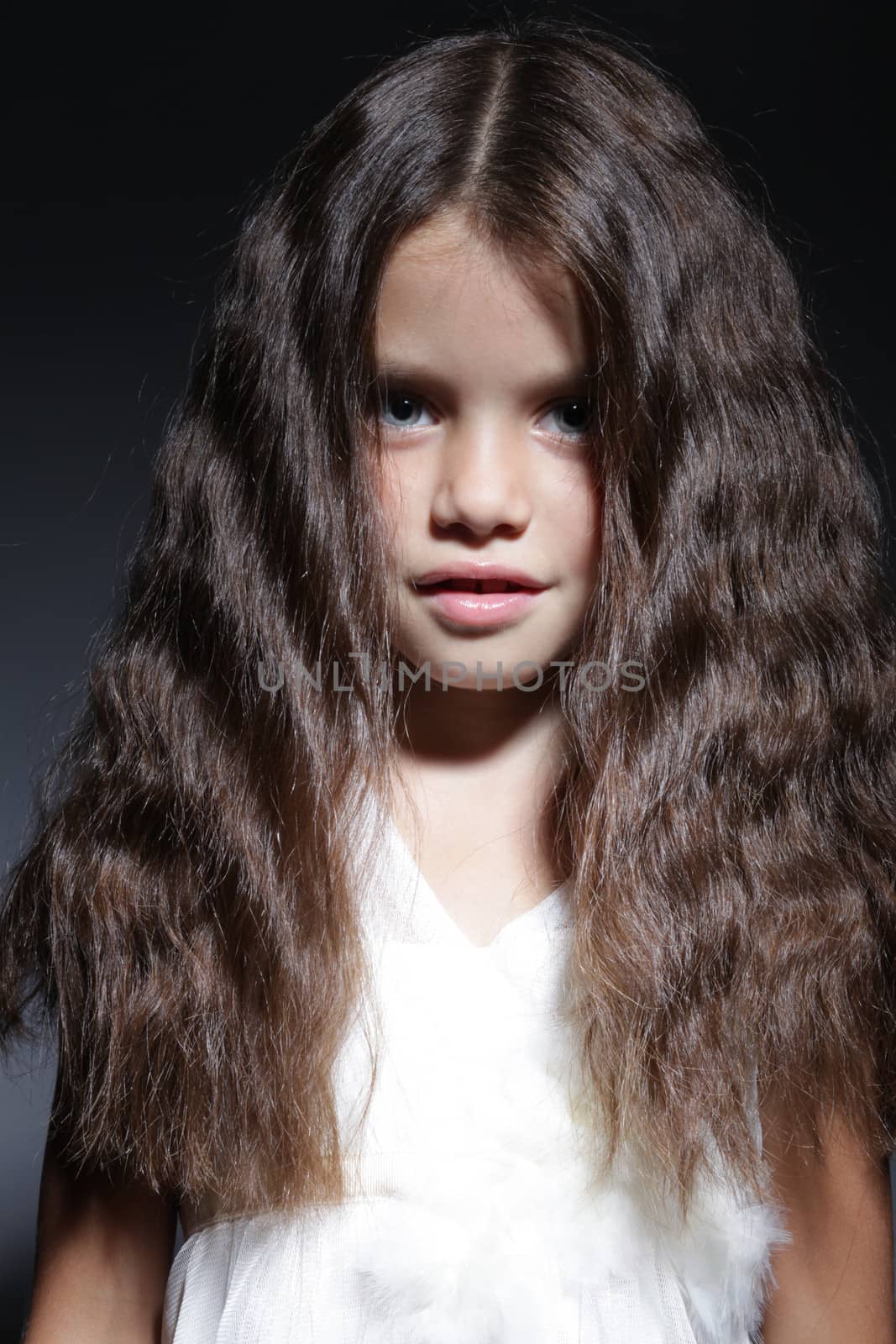 close up portrait of young beautiful little girl with dark hair