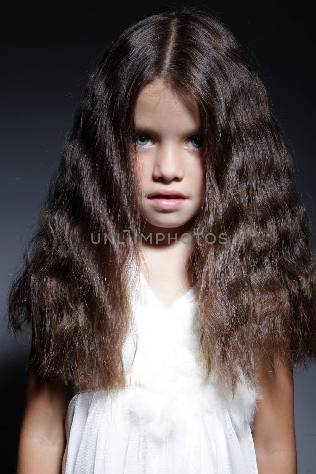 close up portrait of young beautiful little girl with dark hair