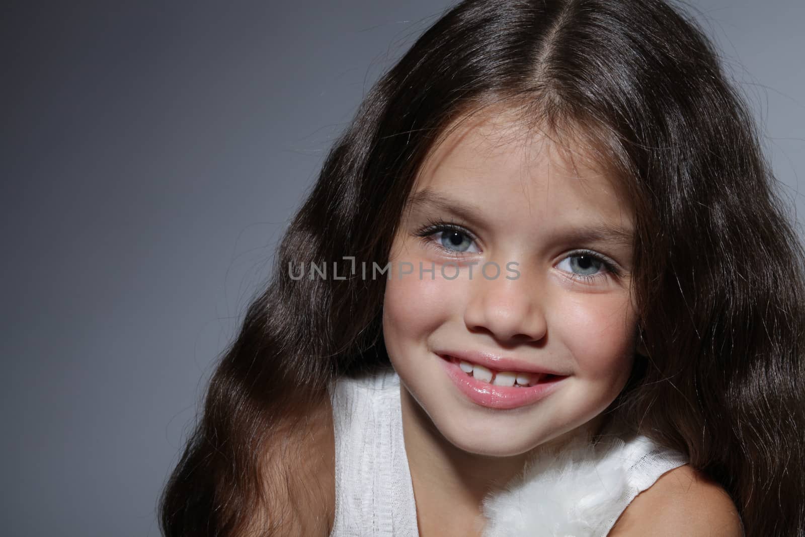 close up portrait of young beautiful little girl with dark hair