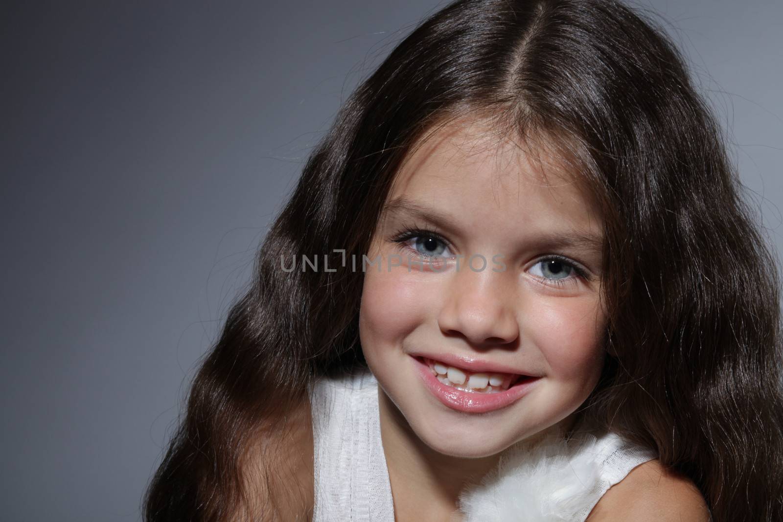 close up portrait of young beautiful little girl with dark hair